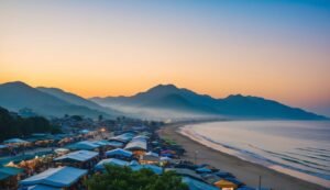 Beach market at sunset with mountains in the background